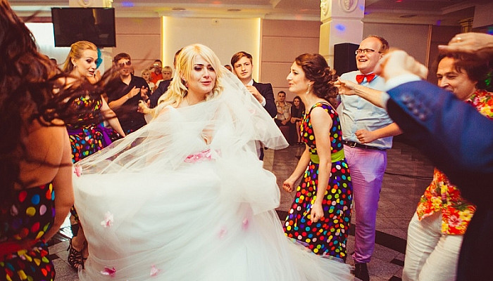 Magnificent bride dancing with friends