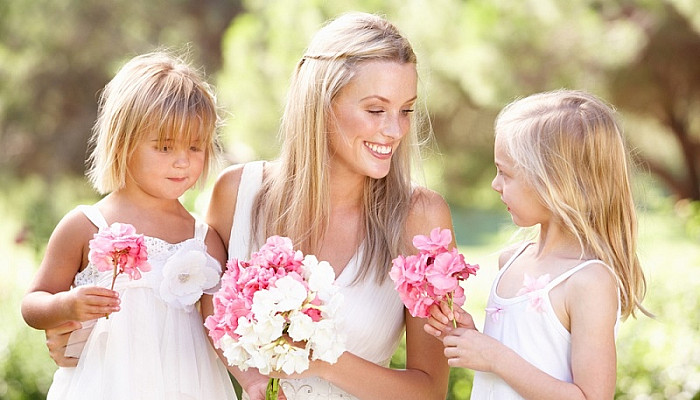 Bride With Flower Girls Outdoors At Wedding