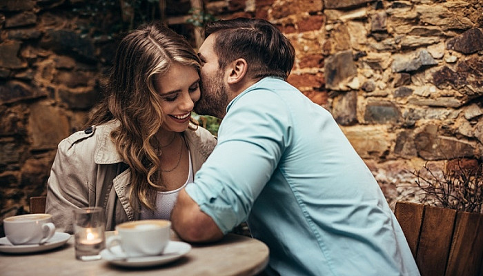 Smiling couple at a coffee shop spending time together