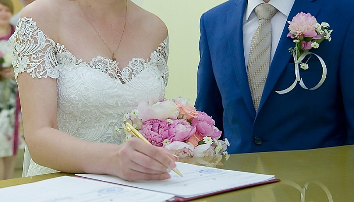 couple signing marriage certificates