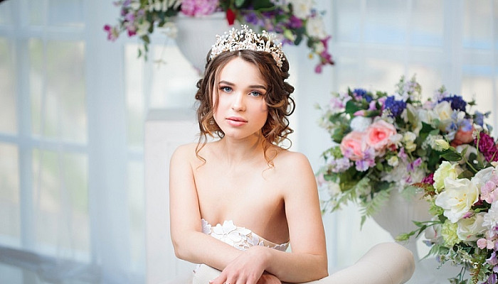 beautiful girl in a wedding dress with tiara