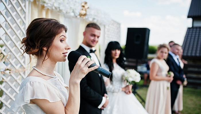 woman giving speech at wedding ceremony