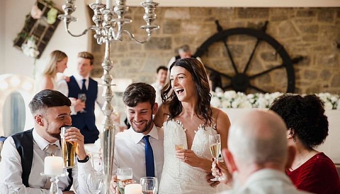 newly wed couple are socialising with guests at their Rehearsal Dinner