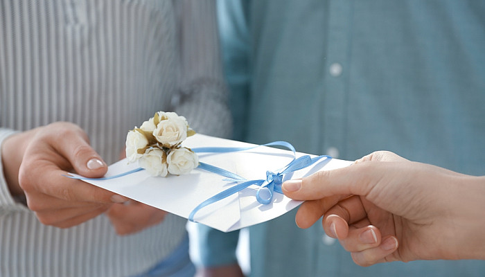 Couple receiving wedding invitation