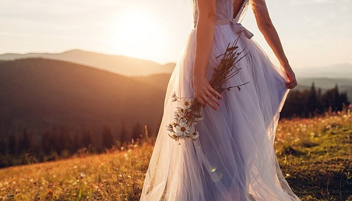 Bride wearing wedding dress holding flower bouquet