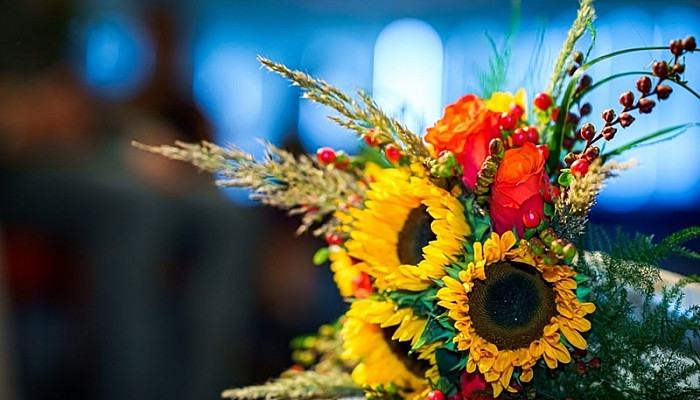 Sunflower wedding bouquet lies on an table of wedding ceremony