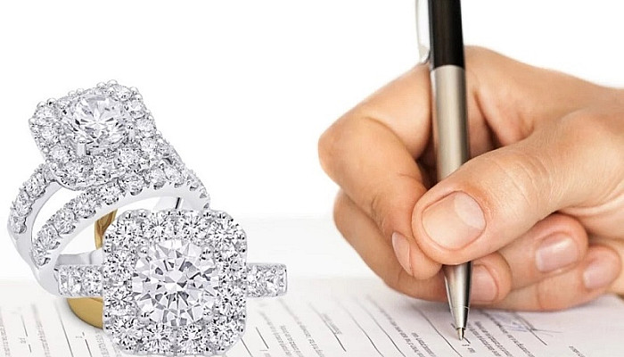 Man signing insurance paper for Engagement Ring