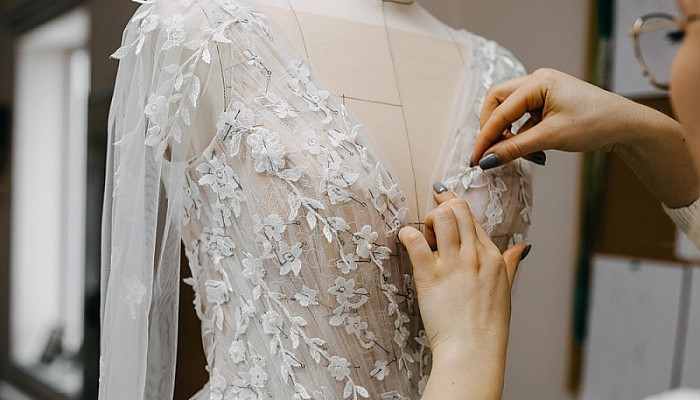 A Fashion designer customize a wedding dress for client at her studio
