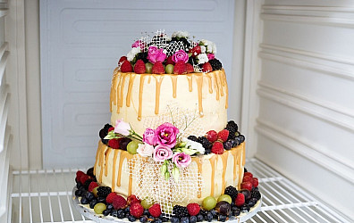 two layers white cream and fruit wedding cake stored inside a fridge