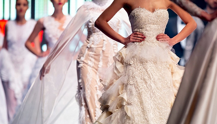 model walking on the runway in wedding dresses during a Fashion Show
